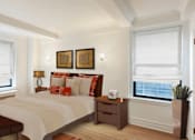 Thumbnail 10 of 18 - A bedroom with a large bed and a window with blinds.at Sutton Collection, New York, 10022