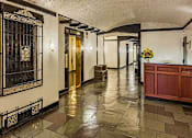 Thumbnail 16 of 18 - A hallway with a black gate and a gold door. at Sutton Collection Apartments, New York