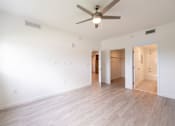 Thumbnail 12 of 22 - A room with a ceiling fan and light fixture.