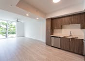 Thumbnail 5 of 22 - A kitchen with wooden cabinets and a white countertop.