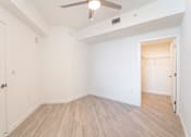 Thumbnail 6 of 22 - A room with a ceiling fan and light fixture.