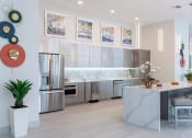 Thumbnail 6 of 36 - a kitchen with stainless steel appliances and a marble counter top