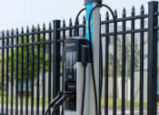 Thumbnail 35 of 36 - an electric bike parked in front of a fence