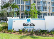 Thumbnail 1 of 36 - a view of a condo building with palm trees in front of it