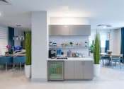 Thumbnail 38 of 41 - a modern kitchen and dining room with blue chairs and a table