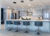 Thumbnail 28 of 41 - a kitchen with an island and four bar stools
