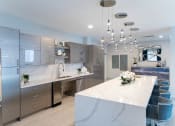 Thumbnail 32 of 41 - a large white kitchen with stainless steel appliances and a marble counter top