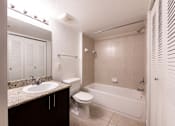 Thumbnail 16 of 33 - A bathroom with a sink, toilet, and bathtub.