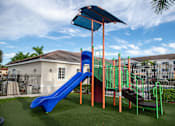 Thumbnail 21 of 23 - A playground with a blue slide and a green and orange structure.