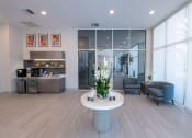 Thumbnail 32 of 36 - a lobby with a white table and chairs