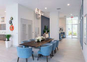 Thumbnail 24 of 36 - a long dining room with blue chairs and a long table