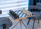 Thumbnail 26 of 41 - a chess board on a table in a room with chairs