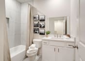 Thumbnail 13 of 16 - a bathroom with a sink and a toilet and a shower