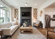 Thumbnail 4 of 16 - a living room with a couch and a table