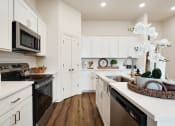 Thumbnail 6 of 16 - a kitchen with white cabinets and stainless steel appliances