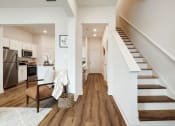 Thumbnail 8 of 16 - a living room with a staircase next to a kitchen