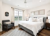 Thumbnail 9 of 16 - a bedroom with a large bed and a window