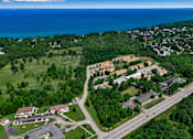 Thumbnail 2 of 2 - A bird's eye view of a residential area with a road running through it.