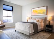 Thumbnail 25 of 52 - A bedroom with a large bed and a painting on the wall.