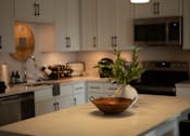 Thumbnail 21 of 52 - A kitchen with a bowl of flowers on the counter at The Pearl, Fort Wayne, Indiana