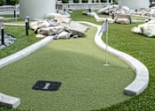 Thumbnail 5 of 52 - A golf hole number 1 surrounded by rocks and sand bunkers.