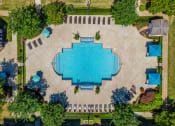 Thumbnail 16 of 26 - an aerial view of a swimming pool in the center of a city with trees