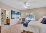 Thumbnail 6 of 26 - a bedroom with a large bed and a ceiling fan