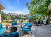 Thumbnail 15 of 26 - a patio with blue chairs and tables and umbrellas
