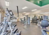 Thumbnail 26 of 26 - a gym with cardio equipment and weights at the village