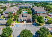 Thumbnail 18 of 26 - an aerial view of a neighborhood of houses with a swimming pool