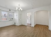 Thumbnail 5 of 34 - A room with a window, a chandelier, and a wooden floor. at Shipyard Shores Apartments, Newport News