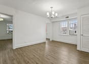 Thumbnail 6 of 34 - A room with wooden floors and white walls at Shipyard Shores Apartments, Virginia