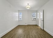 Thumbnail 9 of 34 - A room with wooden floors and white walls at Shipyard Shores Apartments, Apartments, Newport News, VA