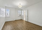 Thumbnail 10 of 34 - A room with wooden floors and white walls at Shipyard Shores Apartments, Newport News, 23607