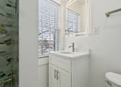 Thumbnail 13 of 34 - A white bathroom with a sink and a bathtub at Shipyard Shores Apartments, Virginia