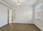 Thumbnail 14 of 34 - A room with a wooden floor and white walls at Shipyard Shores Apartments, Virginia, 23607