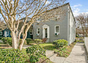 Thumbnail 17 of 34 - A grey house with a tree in front of it at Shipyard Shores Apartments, Newport News, 23607