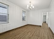 Thumbnail 21 of 34 - A room with wooden floors and white walls at Shipyard Shores Apartments, Virginia, 23607