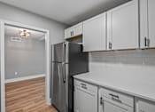 Thumbnail 3 of 51 - A kitchen with a black fridge and white cabinets. at Serenity Place Central, Tallahassee, Florida