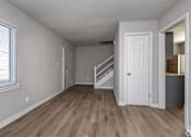 Thumbnail 10 of 20 - A room with a white door and a staircase leading to another room. at Blacklark Apartments, Kansas City, 66101