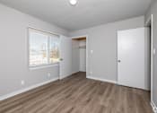 Thumbnail 19 of 20 - A room with a wooden floor and white walls. at Blacklark Apartments, Kansas City