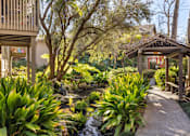Thumbnail 20 of 23 - A garden with a gazebo and a stream running through it at The Aspens Fairhaven, Santa Ana, 92705