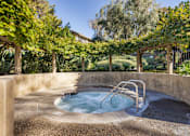Thumbnail 11 of 23 - A hot tub sits in the middle of a garden at The Aspens Fairhaven, Santa Ana, 92705