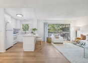Thumbnail 13 of 30 - a living room and kitchen with a sliding glass door to a balcony