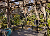 Thumbnail 40 of 42 - A wooden deck with a barbeque overlooking a lake at The Aspens South Coast, California, 92504