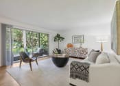 Thumbnail 2 of 30 - a living room with a couch and a table   and large windows