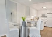 Thumbnail 8 of 30 - a dining room with white chairs and a table