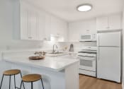 Thumbnail 9 of 30 - a kitchen with a white counter top and white appliances