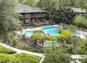 Thumbnail 1 of 19 - an aerial view of the backyard of a house with a swimming pool