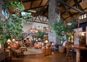 Thumbnail 27 of 30 - the lobby of a clubhouse with a large living room and a staircase